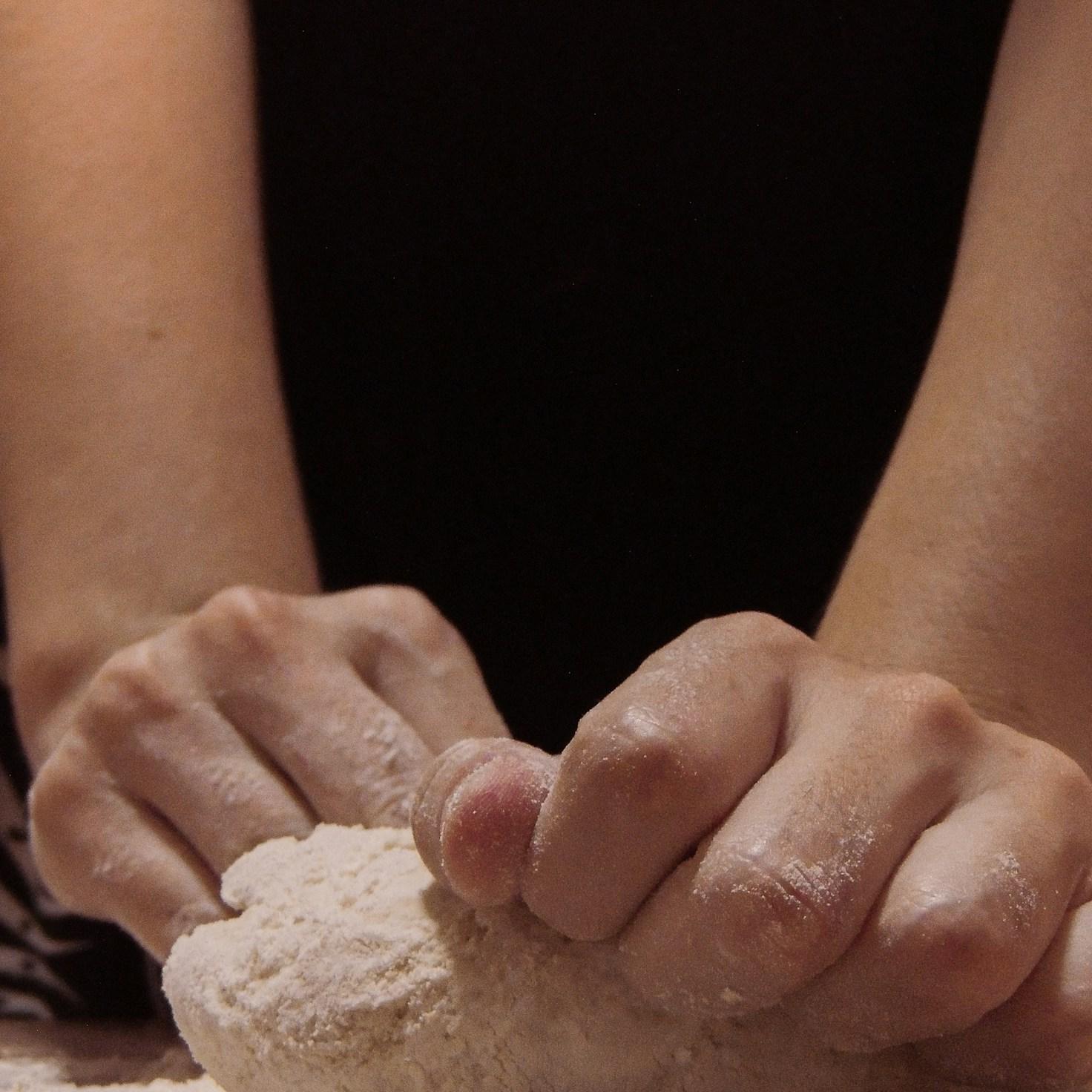 People collaborating in a modern kitchen, sharing recipes and cooking techniques